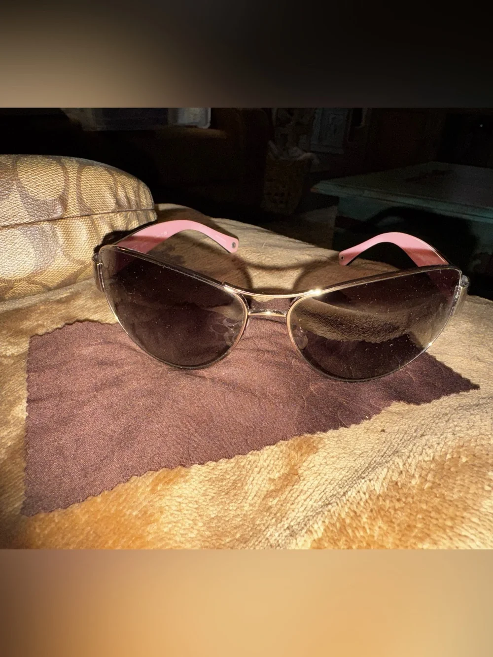 Coach aviator sunglasses with brown lenses and pink temples